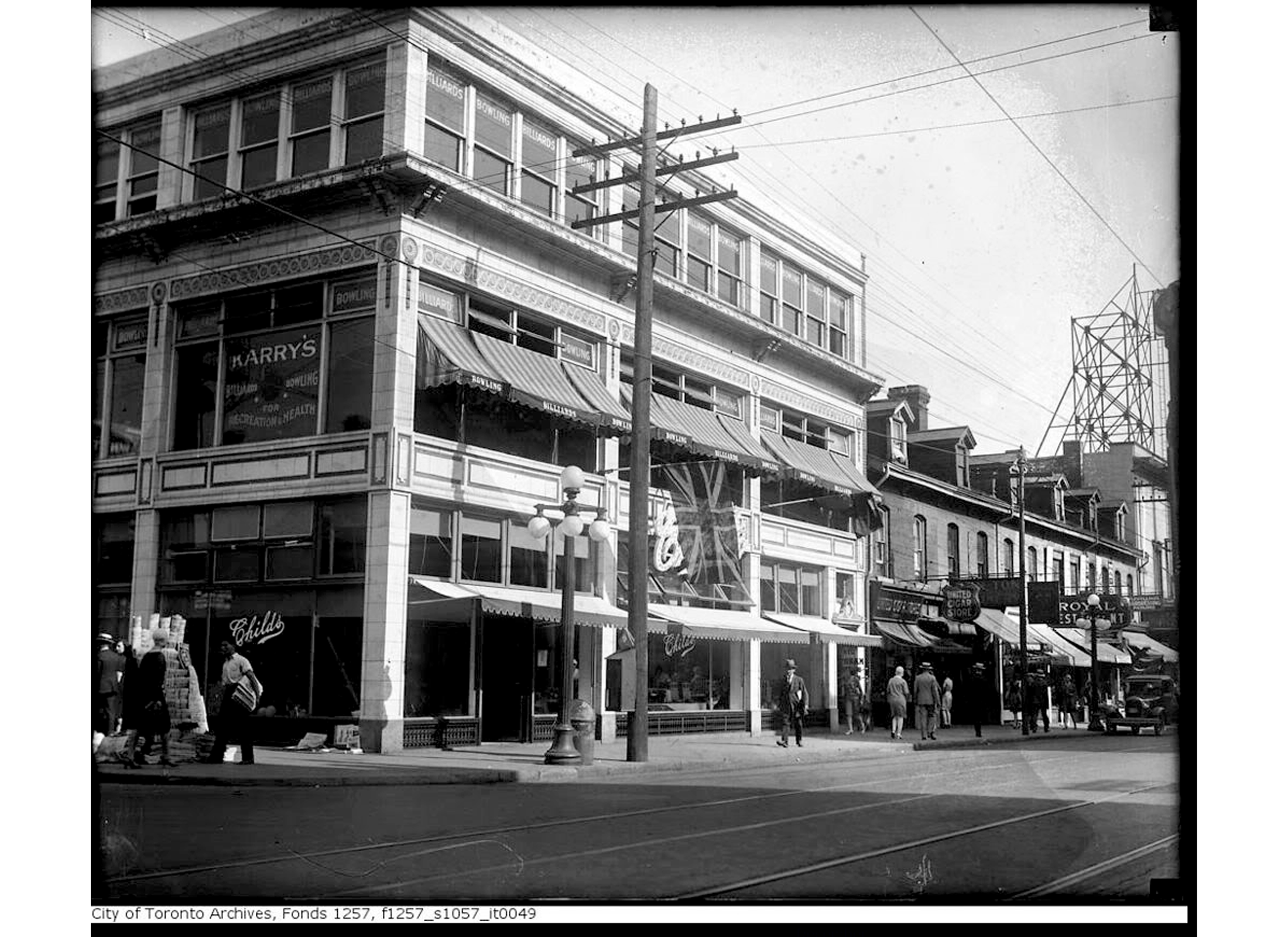 Historical image of 279 Yonge Street, as it operated as a Billiards/Bowling room, and a store on the ground floor. 