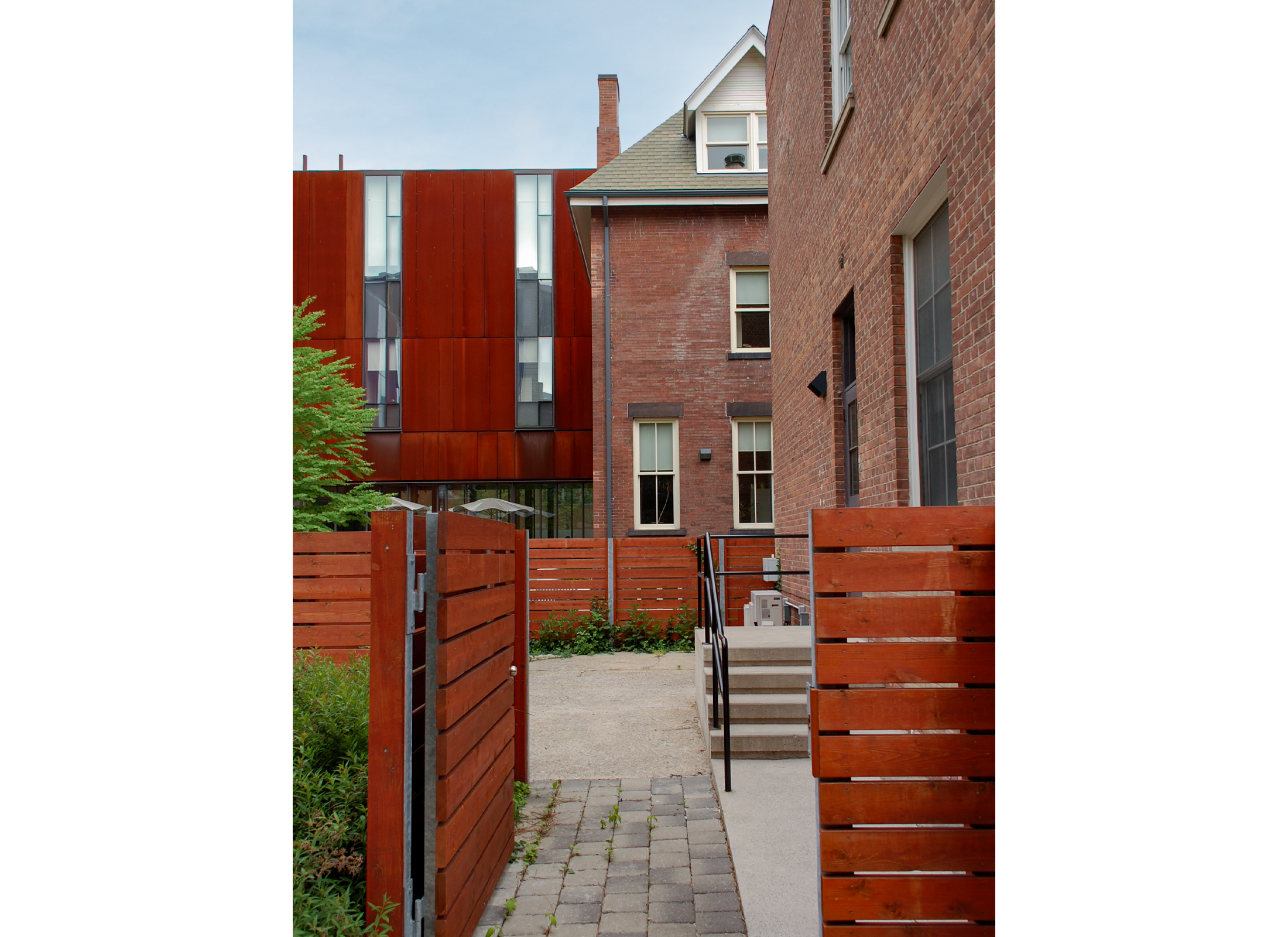 Red wood fence leading into an outdoor area.