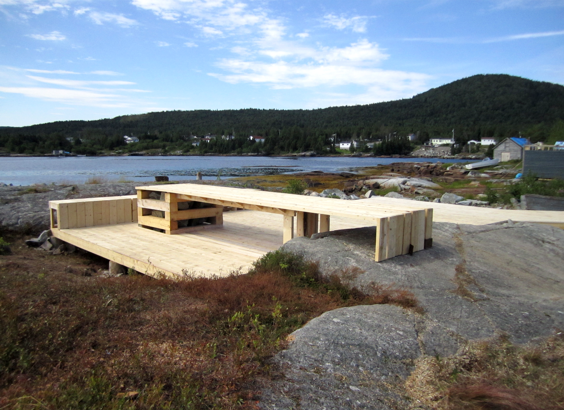 Wood platform and seating area by the waterfront.