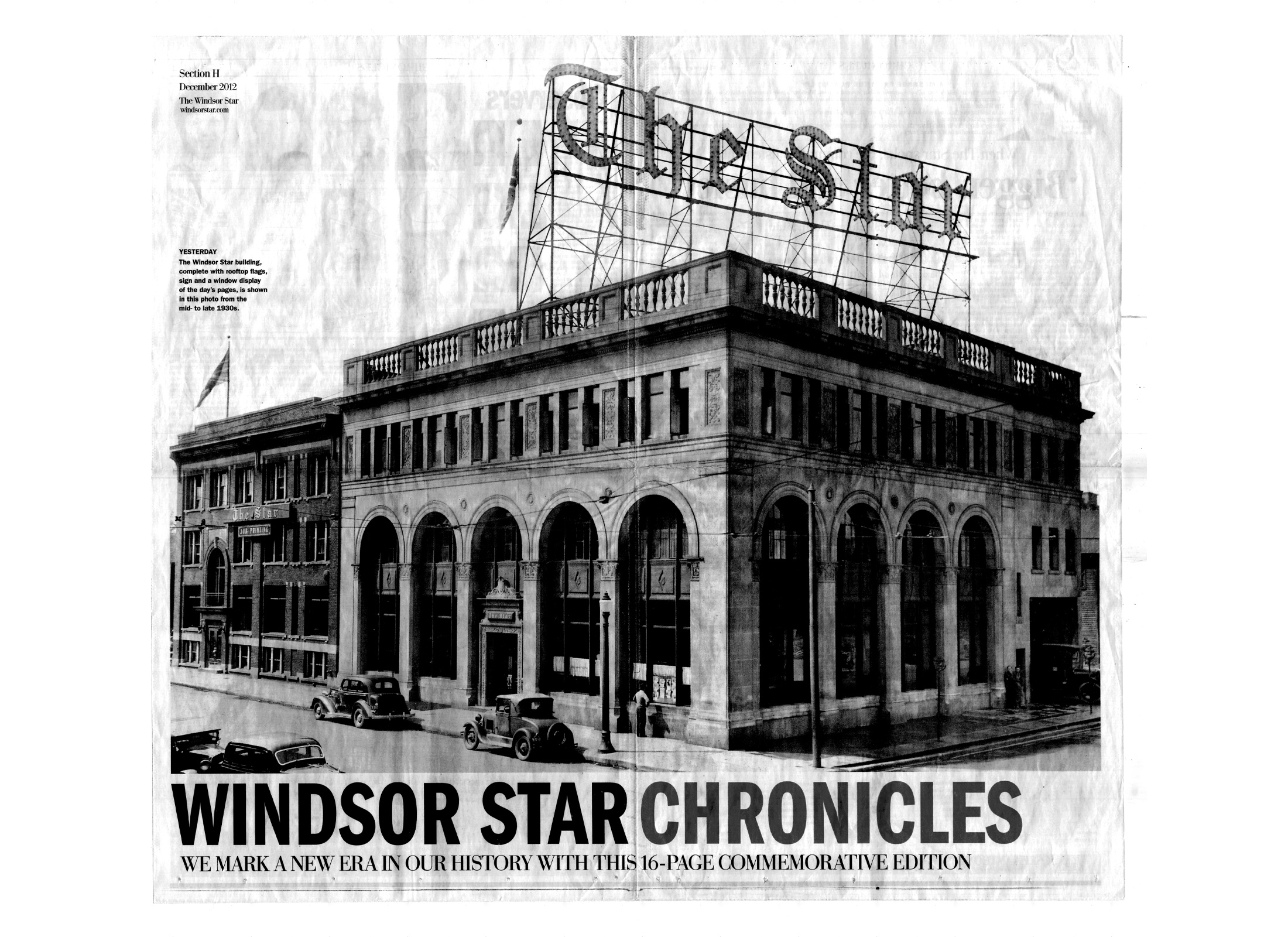 Historical image of the Windsor Star Building, a three-storey building made from stone with arched windows and decorative elements. In this image, the building has a sign that says "The Star" on the roof of the building. 