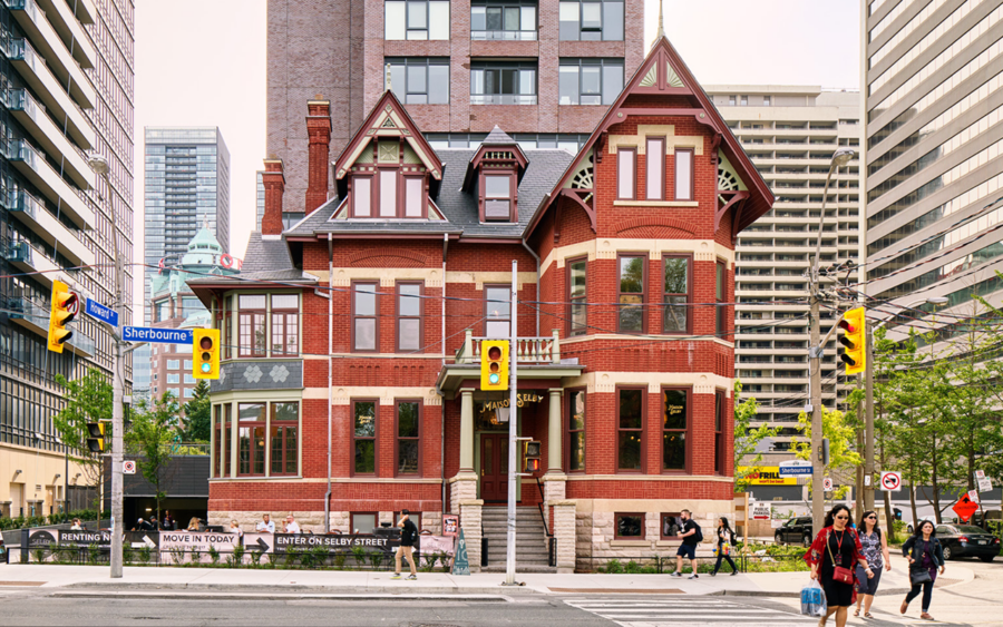 The Selby, a historic Victorian red brick house attached to an adjacent skyscraper.