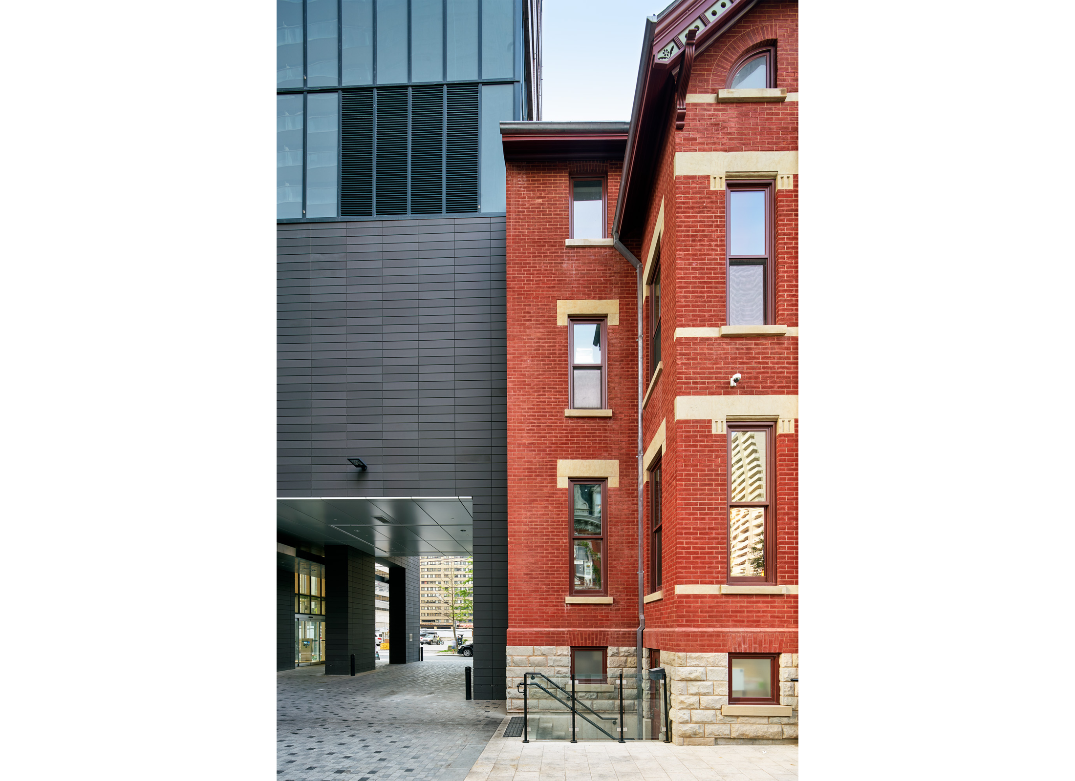 The Selby, a historic Victorian red brick house attached to an adjacent skyscraper.