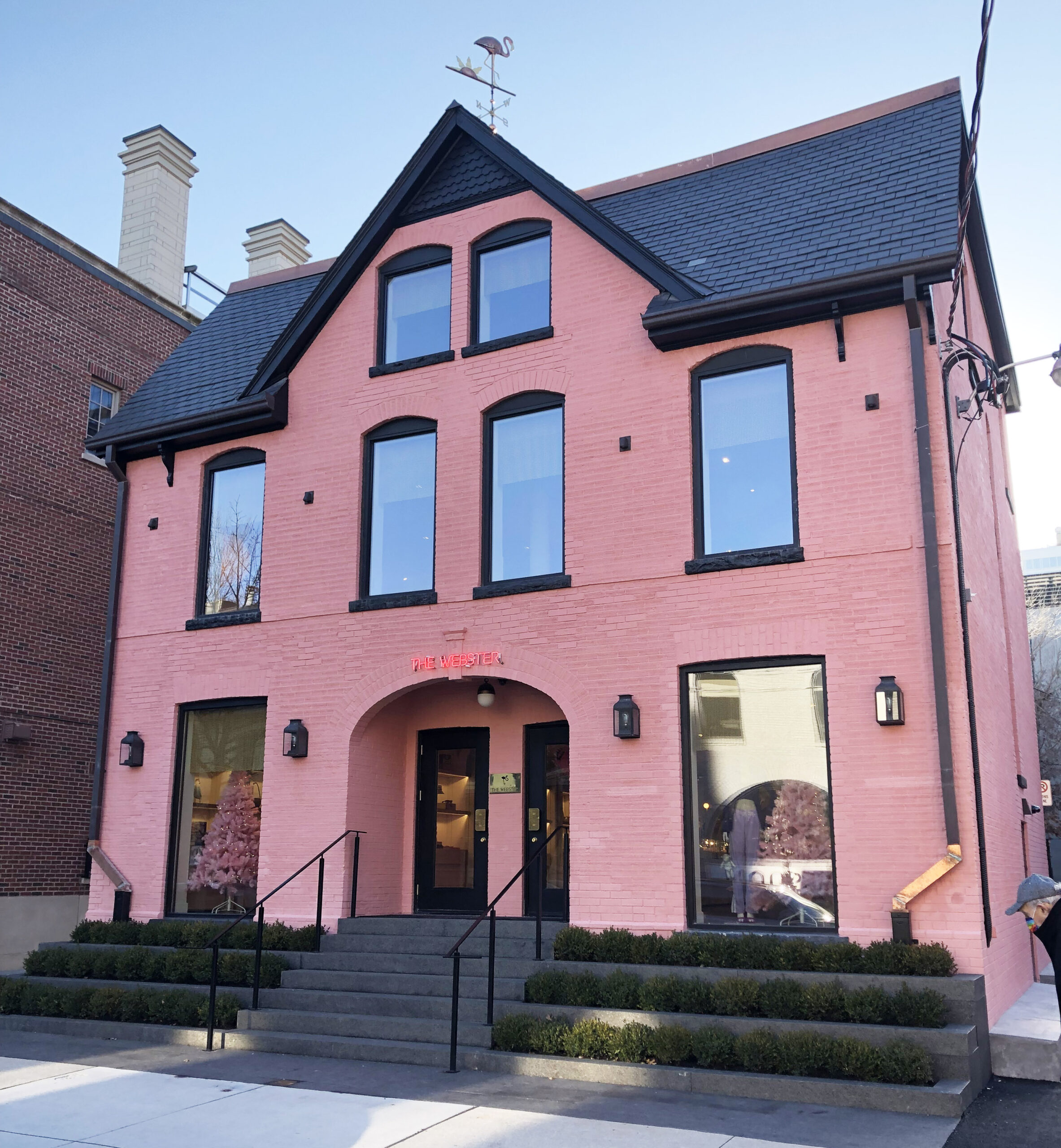 The newly painted building at 121 Scollard is a two and a half storey gable-roof house with a centred dormer peak. 