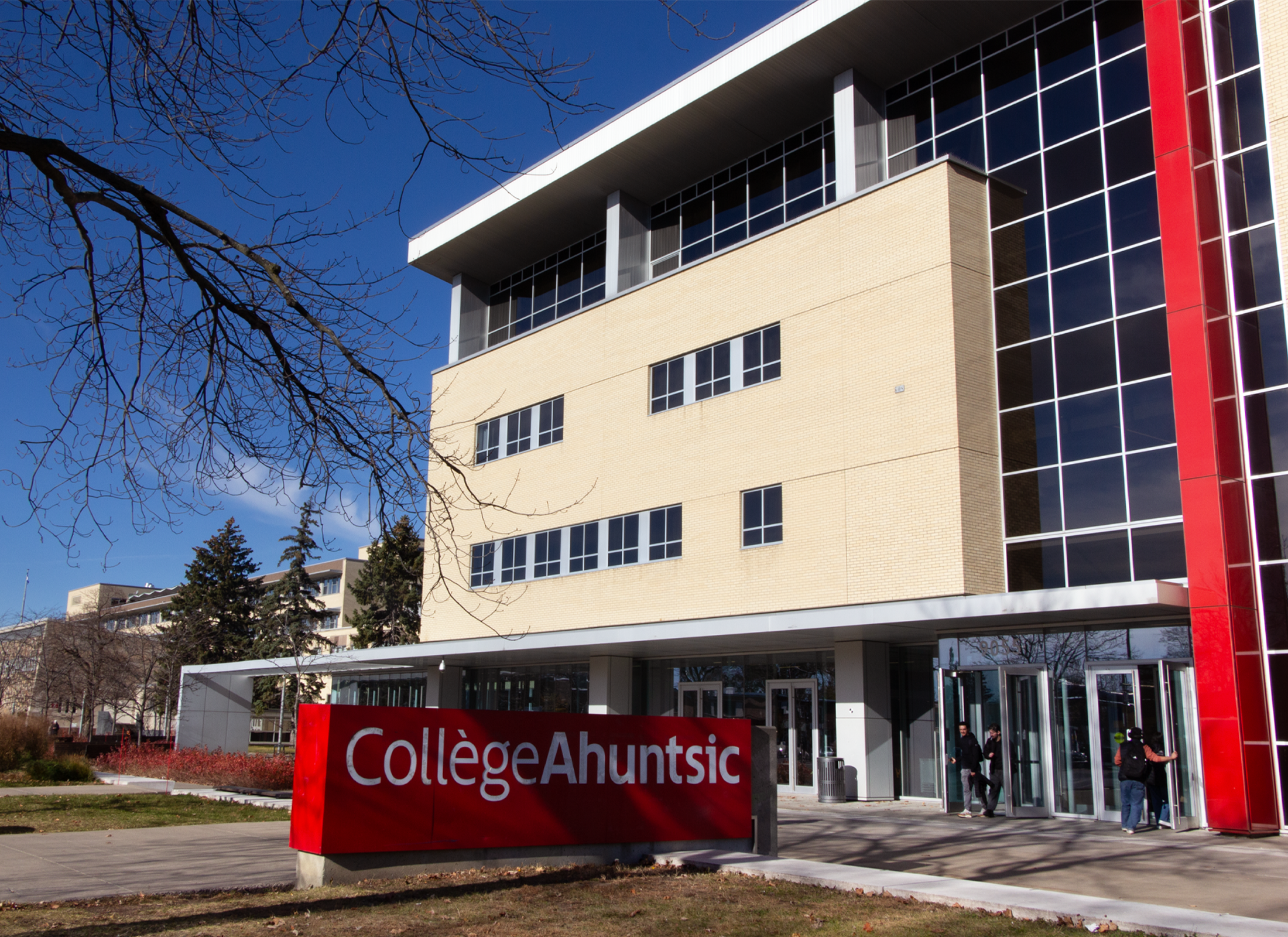 Exterior of Collège Ahuntsic with large red sign