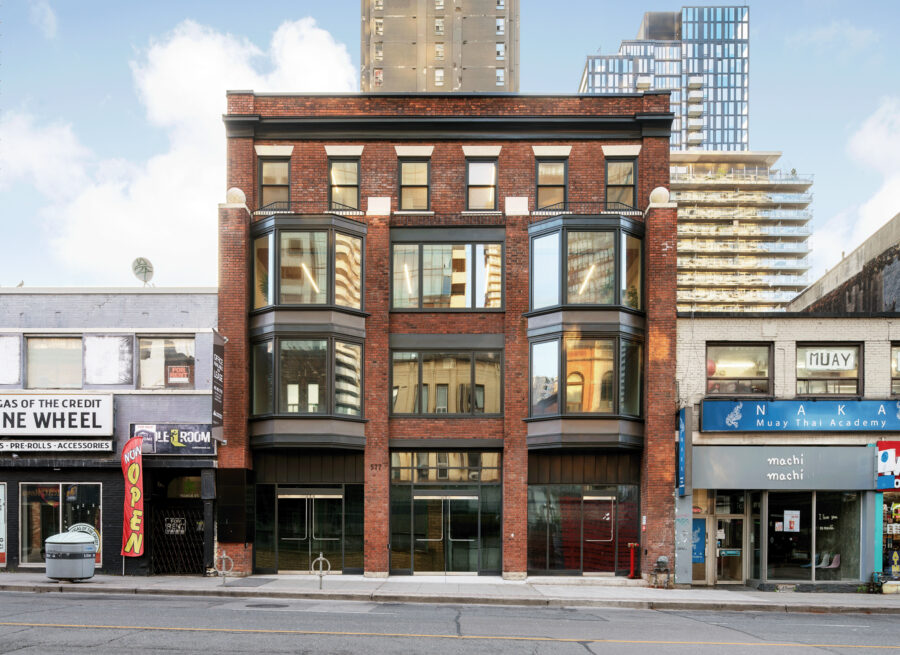 Elevation of 577 Yonge Street, a four storey building featuring red brick and bay windows.