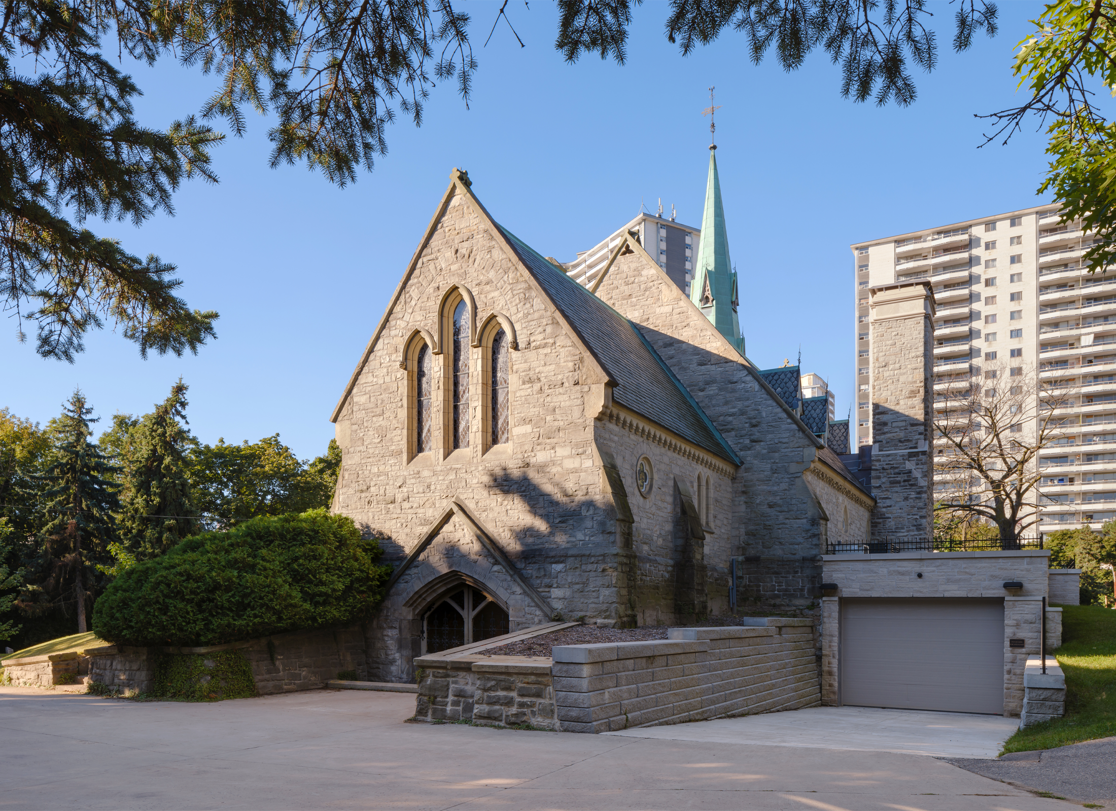 Exterior view of the loading bay at St. James Chapel, a stone church.