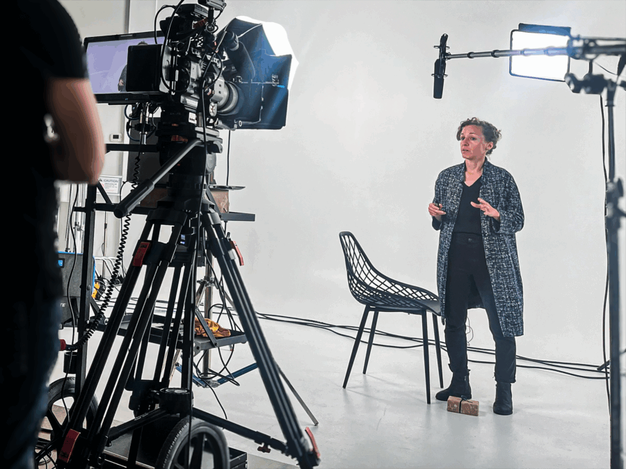 Ya'el Santopinto standing in front of a camera to film Everyday Modern Architecture in Canda.