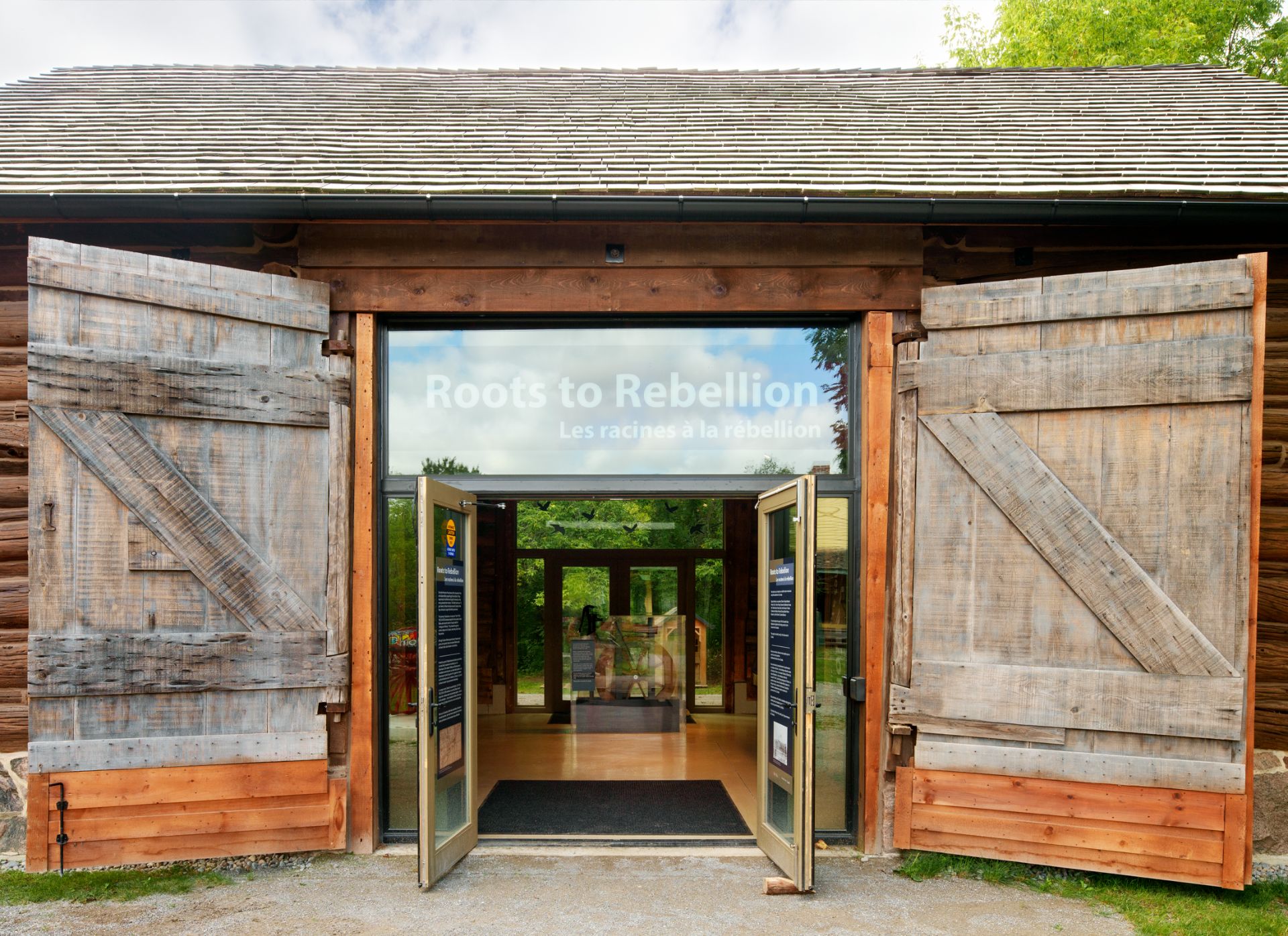 Pickering Museum Village timber building exterior glass door entryway with heritage barn doors