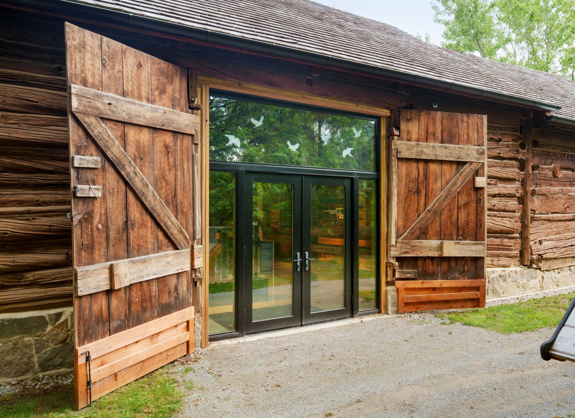 Pickering Museum Village timber building exterior glass door entryway with heritage barn doors