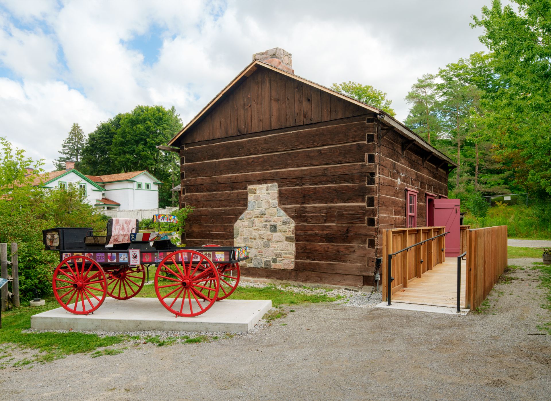 Pickering Museum Village timber building exterior with accessible ramp entry, and heritage carriage display