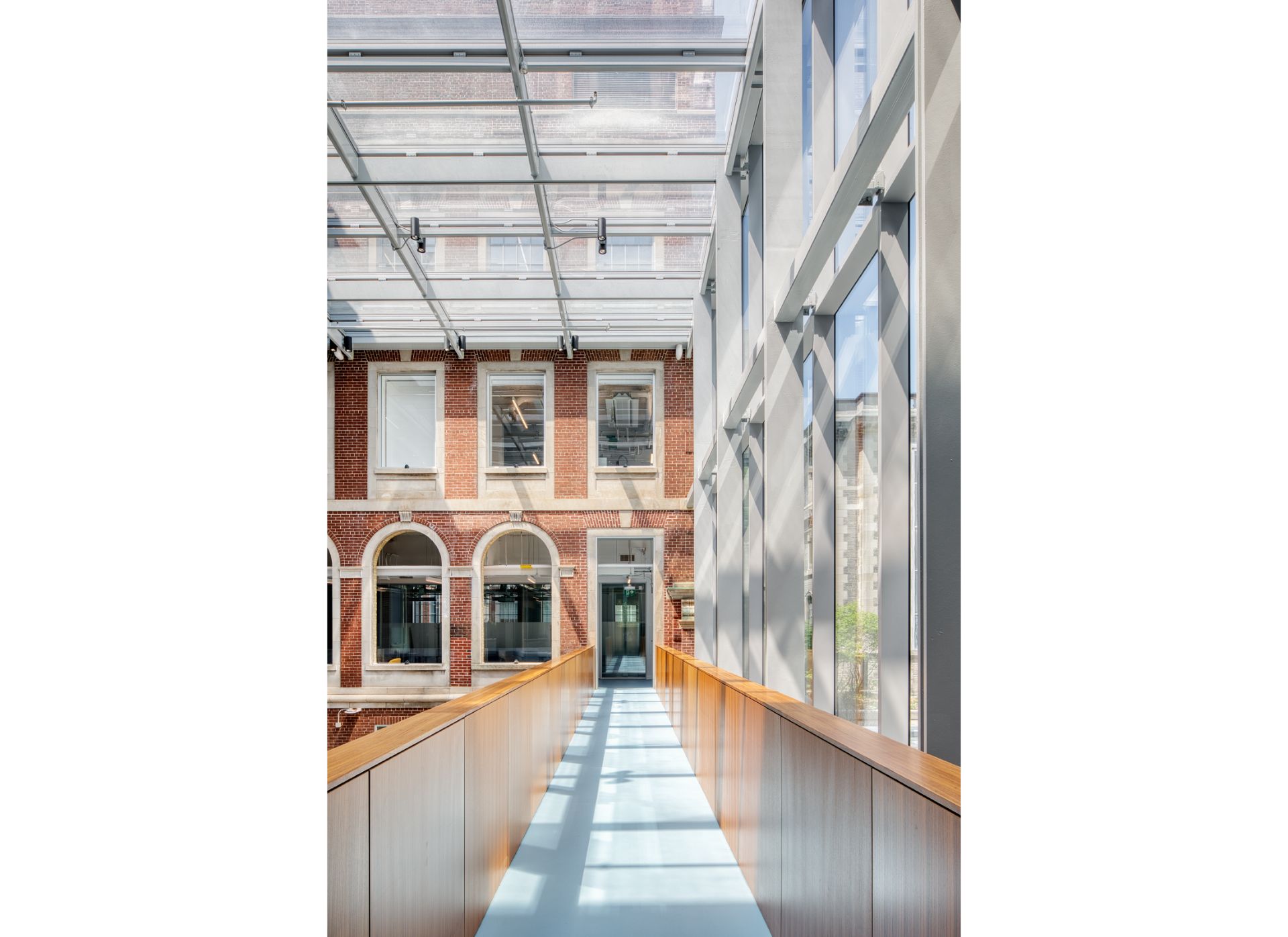 Glass addition of the Fitzgerald building, a three storey Georgian Revival building made of red brick with glass extension.