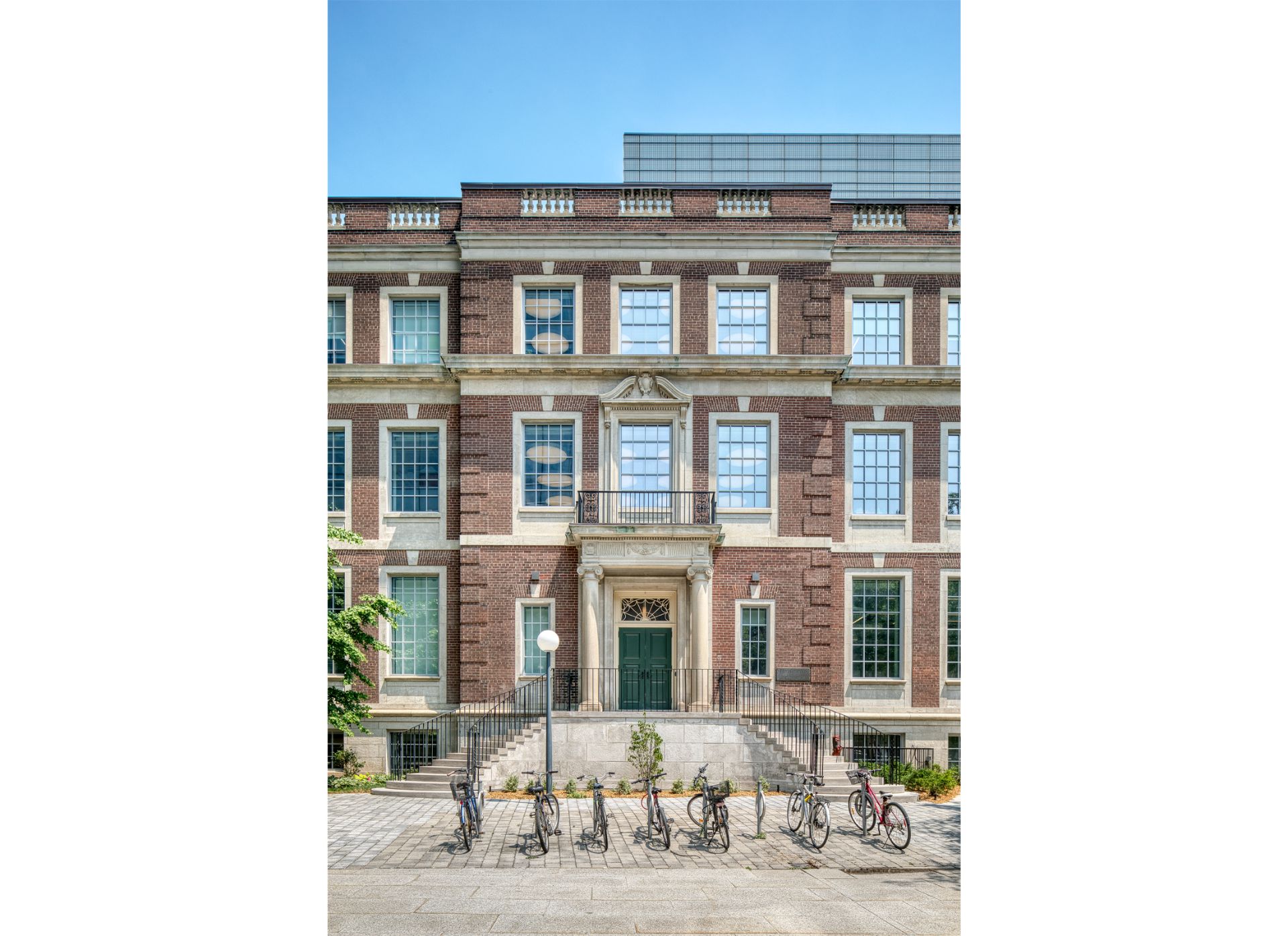Exterior elevation of the Fitzgerald building, a three storey Georgian Revival building made of red brick with rooftop glass extension.