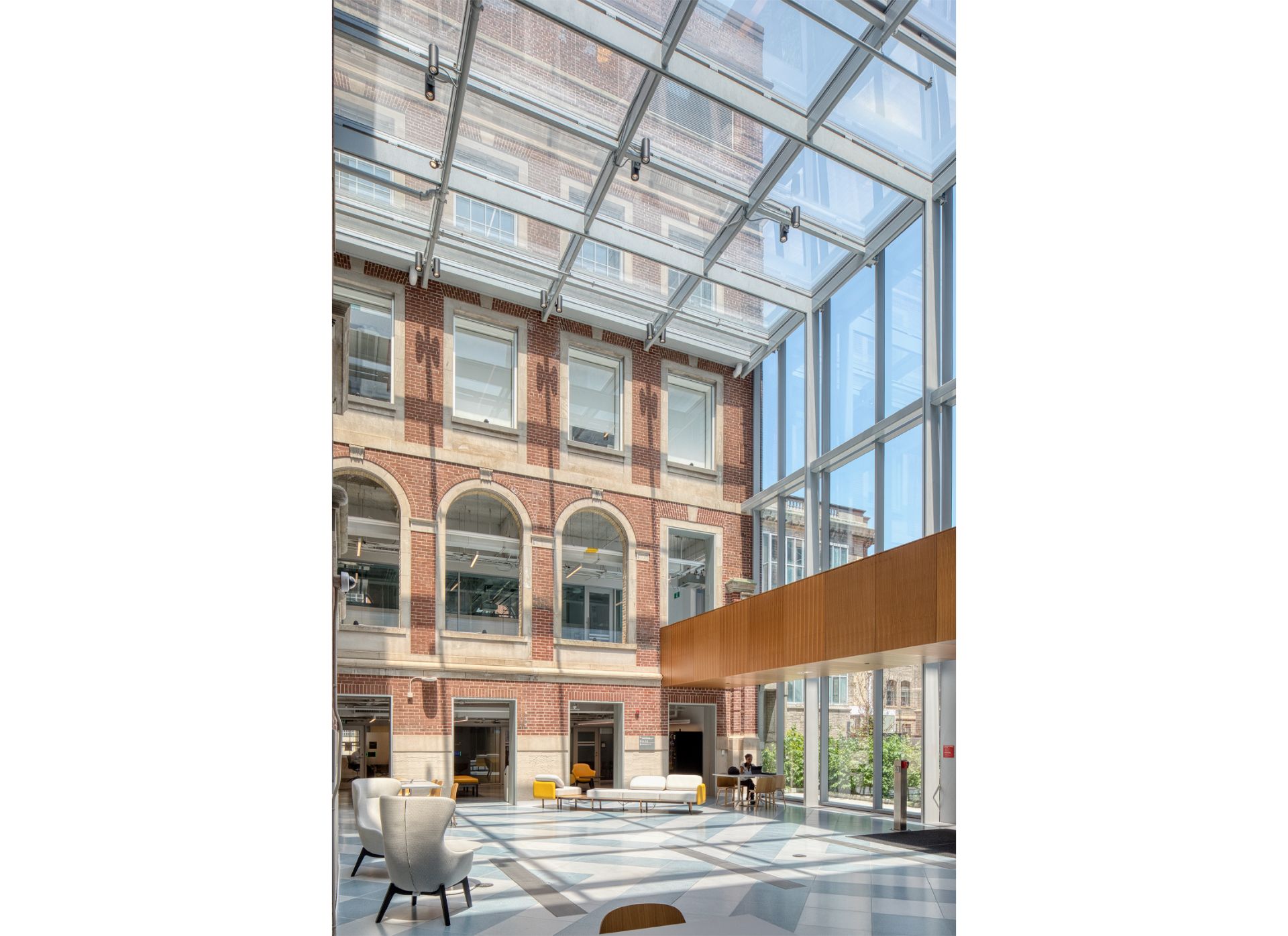 Glass addition of the Fitzgerald building, a three storey Georgian Revival building made of red brick with glass extension.