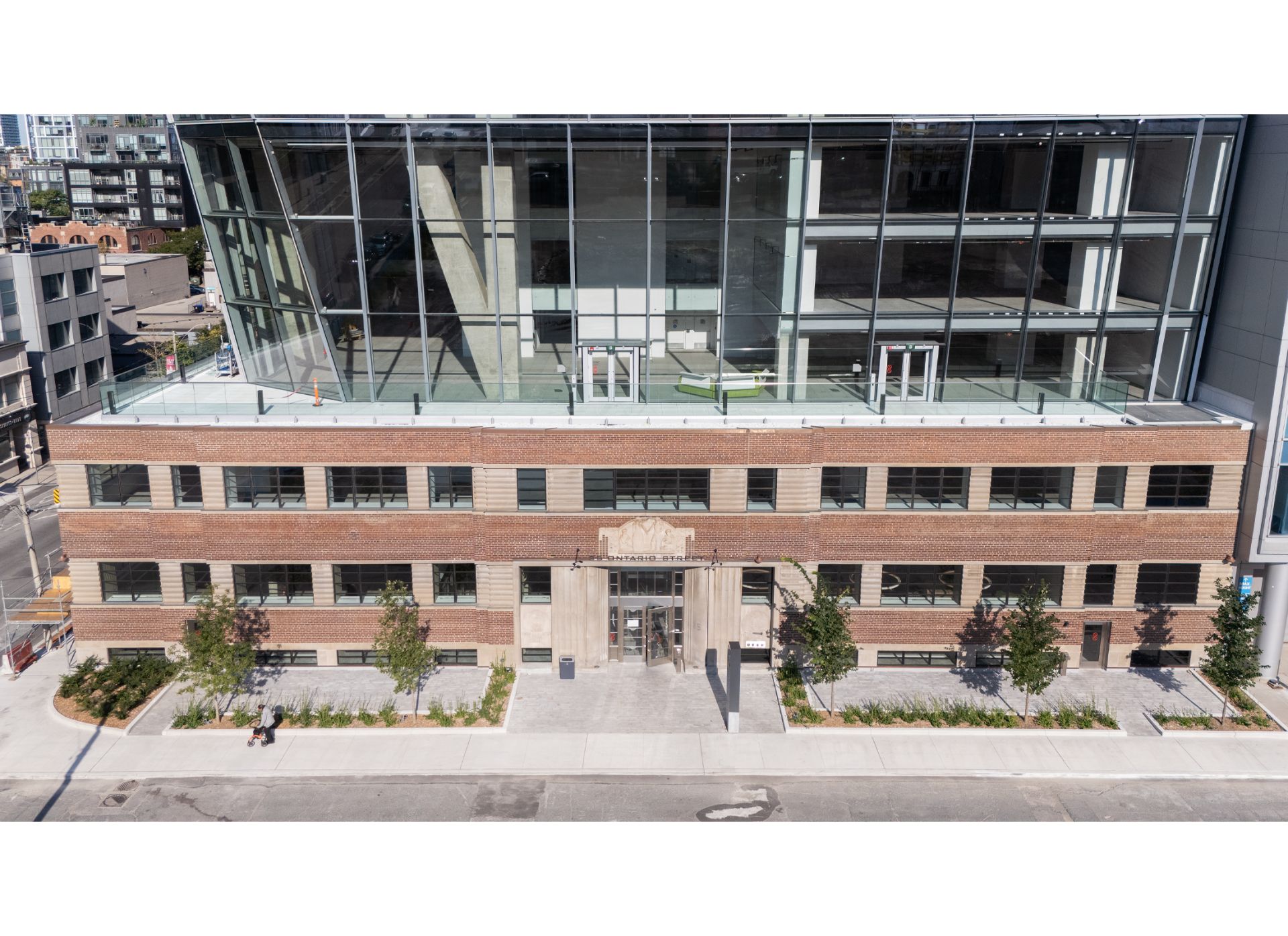 25 Ontario street, a three storey brick heritage building with a large glass tower on top.