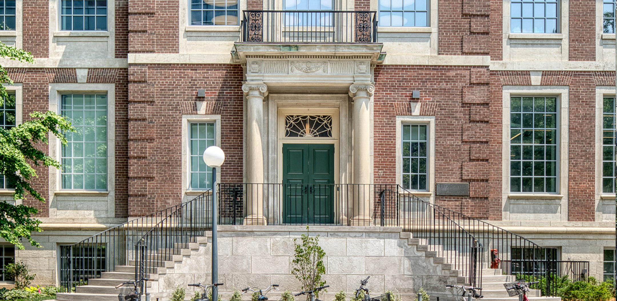 Exterior elevation of the Fitzgerald building, a three storey Georgian Revival building made of red brick with rooftop glass extension.