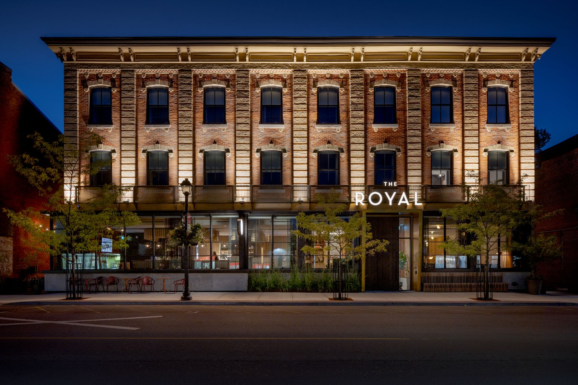 Night time photograph of the Royal Hotel's exterior facade.