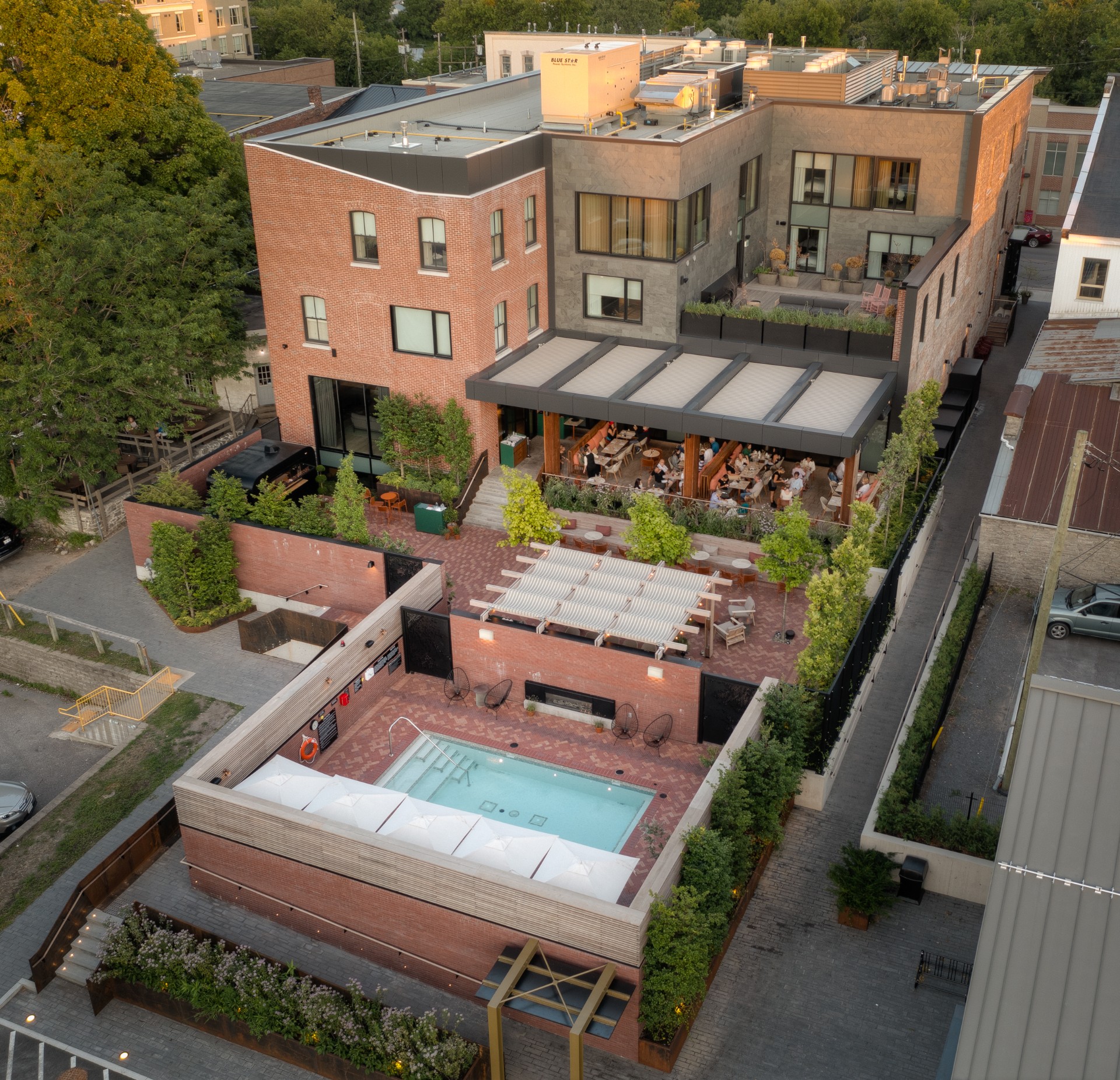 Aerial view of the Royal Hotel building featuring a rooftop terrace and elevated outdoor pool.