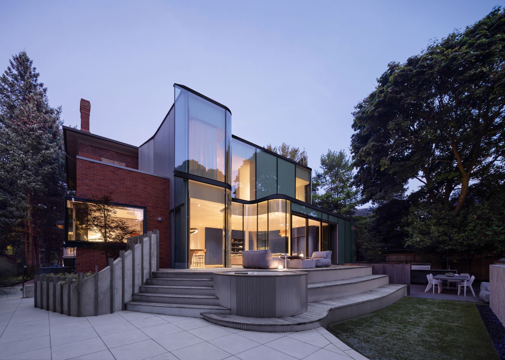 A glass extension added to the existing brick structure of the Snider House.