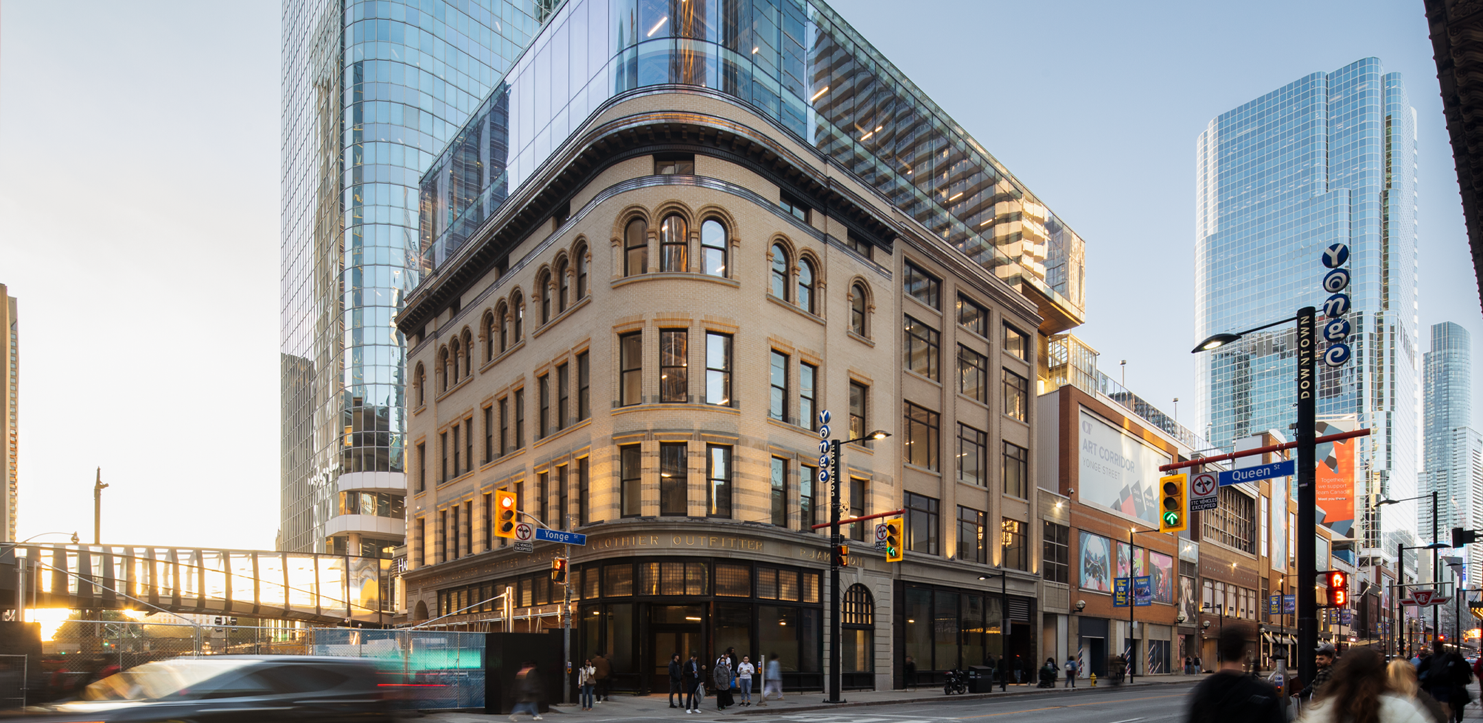 Street facade of 2 Queen Street West building framed by surrounding high-rise development.