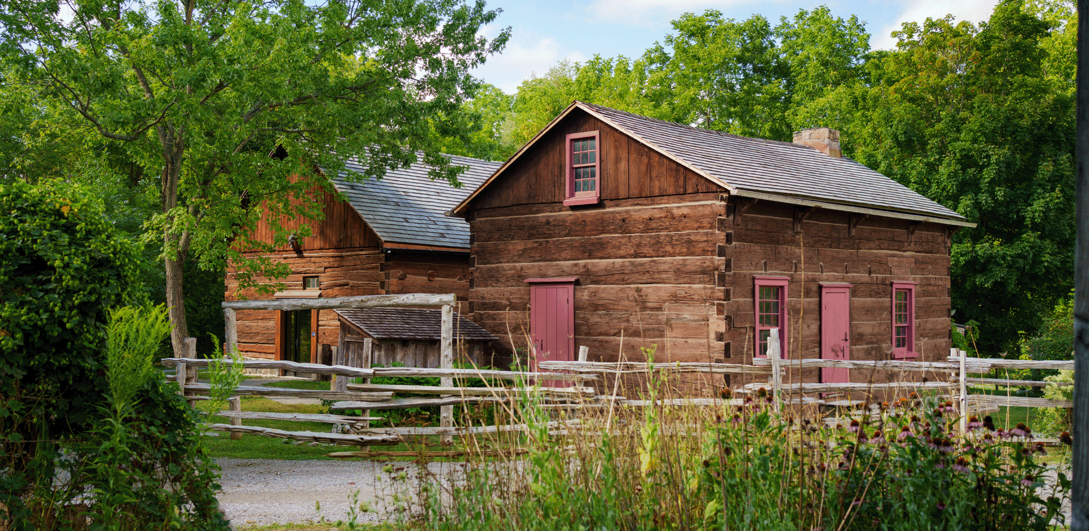 A pair of preserved log buildings at the Pickering Museum Village.